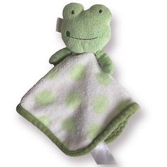 a green and white towel with a frog on it's back, hanging from a hook