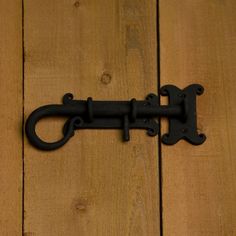 an old black door handle on a wooden floor