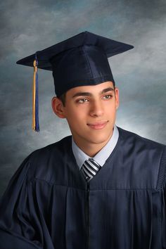 a young man wearing a graduation cap and gown