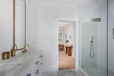 a bathroom with a walk in shower next to a sink