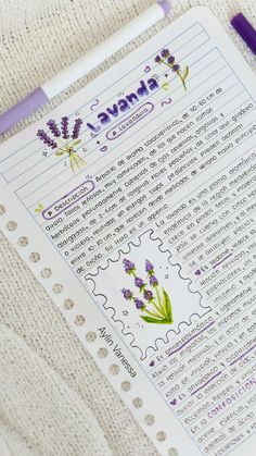 a purple pen sitting on top of a piece of paper next to a notepad