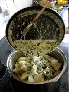 a pan filled with food sitting on top of a stove