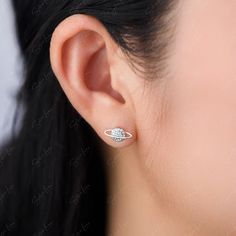 Expertly crafted from 925 sterling silver, these Planet Moon Star Stud Earrings feature sparkling cubic zirconia in a celestial-inspired design. Perfect for lovers of all things cosmic, these earrings add a touch of magic to any outfit. Elevate your accessory game with these unique and stylish earrings. Materials: 925 Sterling Silver, cubic zirconiaFinish: platinum plateDimensions:Planet: 0.43 x 0.21 inMoon: 0.27 x 0.18 in Jewelry Care: See more information about how to care for your jewelry her Sterling Silver Star-shaped Diamond Earrings, Sterling Silver Space-themed Jewelry, Celestial Sterling Silver Jewelry, Silver Star-shaped Diamond Earrings As Gift, Silver Star-shaped Diamond Earrings For Gift, Star Stud Earrings, Stylish Earrings, Silver Jewelry Earrings, Tiny Studs