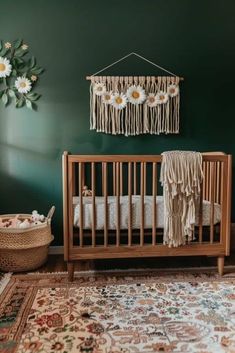 a baby crib in a green room with flowers on the wall and rugs