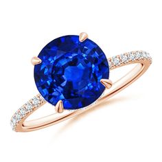 an oval blue sapphire and diamond ring in rose gold with diamonds around the band, on a white background