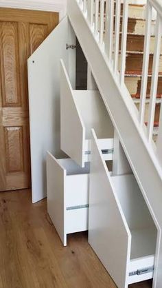 an under stairs storage unit with drawers underneath