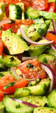 a salad with cucumbers, tomatoes and onions