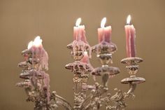 a chandelier filled with lots of lit candles