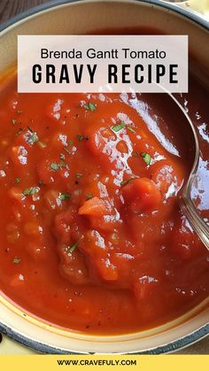 a bowl filled with tomato soup and garnished with parsley on the side