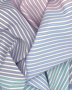 multicolored striped fabric close up on white and blue background, with diagonal stripes