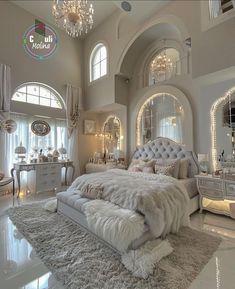 a luxurious bedroom with chandelier, mirror and bed in the middle of the room