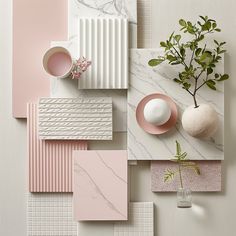 an assortment of pink, white and grey tiles with plants in vases on top