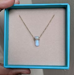 This moonstone has mini diamonds wrapped around it as if they are giving it a little hug! The moonstone has beautiful flashes of blues and purples. Fun, unique, and modern, this necklace won't disappoint! Layer it up with our other dainty chokers and chains for a fun and stylish look. Adjustable chain from 16 to 18 inches. Moonstone (3.270ct) Diamonds (0.05ct) 14k rose gold Pendant: 14x9mm Elegant Moonstone Necklaces For Healing, Elegant Moonstone Healing Necklaces, Luxury Opal Gemstone Necklaces, Luxury Opal Gemstone Necklace, Moonstone Necklaces With Gemstone Accents, Round Moonstone Necklace With Gemstone Accents, Luxury Moonstone Necklace With Gemstones, Elegant Opal Necklace With Wire Wrapped Detail, Moonstone Pendant Necklace With Stones