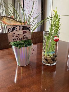 some plants and rocks on a table with a sign that says gone fishing it's catch you later