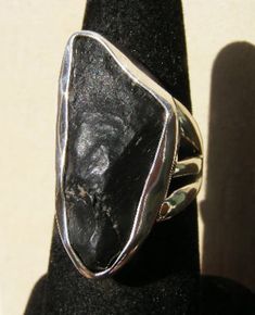 "This ring is ON RESERVE for Kevin, who will be putting down a $50 deposit, the balance will be paid in January! This one of a kind ring features an impact stone from the Zhamanshin Crater! The Zhamanshin crater was created about a million years ago, when the earth and asteroids collide! This ring is a size 8, the natural impact stone measures approximately 1\" in length, and 3/8\" wide! Handmade by Ancient Echos in California. ( AncientEchos ) For any questions or for International shipping inq Hand Cast Freeform Jewelry For Gifts, Artisan Hand Cast Black Jewelry, Artisan Black Hand Cast Jewelry, Artisan Black Hand-cast Jewelry, 50 Dollars, Silver Work, Raw Stone, Stone Ring, Rings Statement