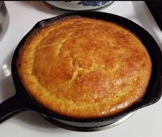 a skillet sitting on top of a stove next to a bowl and utensils