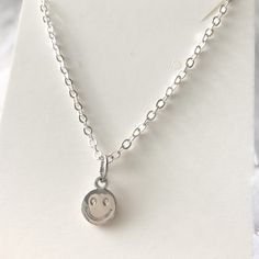 Silver smiley face necklace with a 5cm extended chain (total 45cm), so it is adjustable. This necklace is a hypoallergenic, minimalist and dainty necklace, perfect for layering with another chain! The pendant sits slightly above your breast bone. This is a handmade and packed by myself :) I also sell a gold version of this necklace which can be found on my Etsy! This has a stainless-steel chain, so it will not fade when it comes into contact with a little of water. In case your jewellery comes into contact with water/liquids, quickly take a cloth and wipe it dry, your necklace should not tarnish or oxidise! I would not recommend showering/ constantly exposing this necklace to water, to make sure the charm, the chain and other components keep their gorgeous shine! This charm is made of a zi Simple Hypoallergenic Charm Necklaces As Gift, Cute Hypoallergenic Sterling Silver Necklaces, Simple Hypoallergenic Charm Necklaces For Gifts, Cute Hypoallergenic Sterling Silver Necklace, Trendy Hypoallergenic Charm Necklaces For Gift, Trendy Hypoallergenic Charm Necklace For Gift, Trendy Hypoallergenic Charm Necklaces As Gifts, Minimalist Hypoallergenic Charm Necklace For Everyday, Trendy Silver Round Charm Necklaces