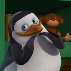 a cartoon penguin with a monkey in the background