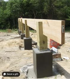 some wooden posts sitting in the dirt