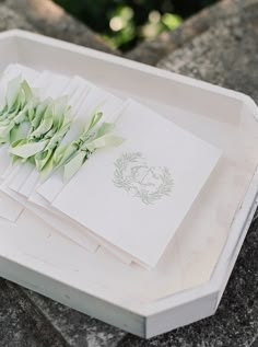 there is a white tray with napkins and flowers on it