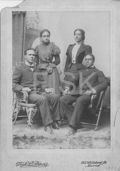 an old black and white photo of four people