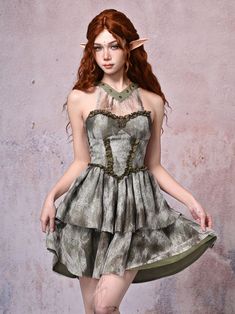 Capture the whimsical essence of a forest fairy with our enchanting light green halter neck basque waist Tie-dyed dress. This flowing, tiered skirt dress features a mesmerizing tie-dye pattern reminiscent of a magical forest, while the halter neck and basque waist add a touch of ethereal elegance. The smocked elastic at the back ensures a comfortable and flattering fit, while the flowing silhouette exudes a carefree, wanderlust spirit. Embrace the wanderer within and float through the day in thi Green Sleeveless Fairycore Dress, Green Sleeveless Fitted Fairy Dress, Green Fairycore Dress For Summer, Fitted Fairy Grunge Dress With Ruffles, Spring Fairy Grunge Dresses With Ruffles, Fairy Grunge Fitted Dresses With Ruffles, Fairy Grunge Fitted Ruffle Dresses, Spring Fairy Grunge Dresses, Fairy Grunge Spring Dresses