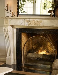 a fire place with a mirror above it