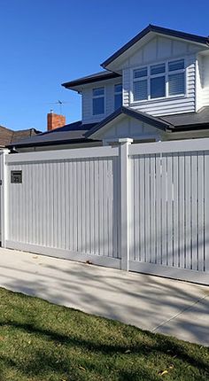 a white fence in front of a house