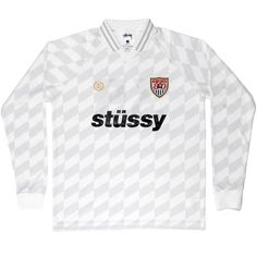 a white soccer jersey with the word stussy printed in black and red on it