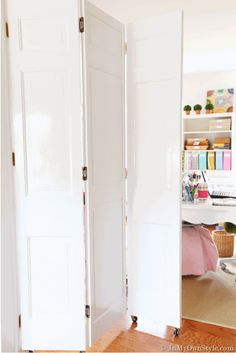 an open white door leading to a bedroom