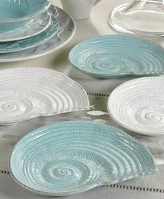 blue glass plates and dishes on a table