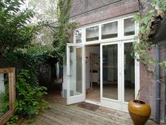 an outside view of a house with wooden decking