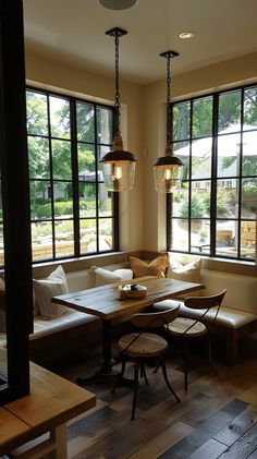 a living room filled with furniture and large windows