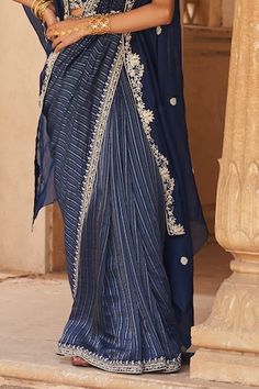 Blue saree with stripe print and neelkamal thread embroidered border. Comes along with coordinating embroidered blouse, cape and belt. - Aza Fashions Blue Pre-draped Saree For Eid And Traditional Ceremonies, Blue Pre-draped Saree For Traditional Ceremonies, Elegant Blue Pre-draped Saree With Dori Work, Blue Saree With Dori Work For Traditional Ceremonies, Sheer Dupatta Blouse Piece For Traditional Ceremonies, Traditional Drape Blouse Piece With Sheer Dupatta For Ceremonies, Blouse Sleeveless, Blue Saree, Printed Sarees