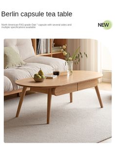 a coffee table with two pears on it in front of a couch and window