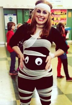 a woman in a costume that looks like a cat is standing on the floor with her hands behind her back