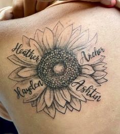 a woman's back with a sunflower tattoo on her shoulder and the words, weather