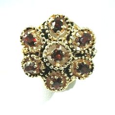 This exquisite vintage ring is crafted from 14K yellow gold and features a large cluster of oval garnets. The ring is size 6 and sizable, it weighs 11 grams. The setting style is a beautiful cluster, making this ring a unique addition to any fine jewelry collection. The main gemstones shape is oval, and the ring is an original piece, not a reproduction. The ring falls under the categories of Rings, Vintage & Antique Jewelry, and Jewelry & Watches. 14K .585 YELLOW GOLD VINTAGE  1 CARAT GARNET FLO Classic Oval Multi-stone Cluster Ring, Classic Oval Cluster Ring With Multi-stone, Luxury Oval Gemstone Flower Ring, Oval Multi-stone Flower Ring For Anniversary, Oval Multi-stone Flower Ring Gift, Classic Oval Flower Ring, Heirloom Oval Flower Ring Hallmarked, Oval Hallmarked Flower Ring In Fine Jewelry Style, Antique Oval Flower Ring For Formal Occasions