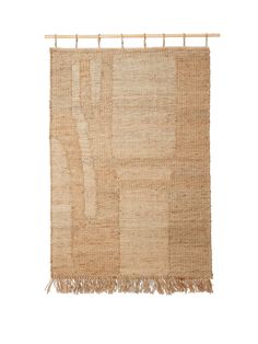 a beige rug with fringes hanging on a clothes line against a white background,