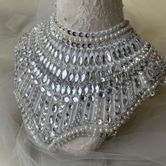 a mannequin is adorned with crystal beads