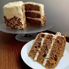 a slice of cake on a plate next to the rest of the cake that has been cut