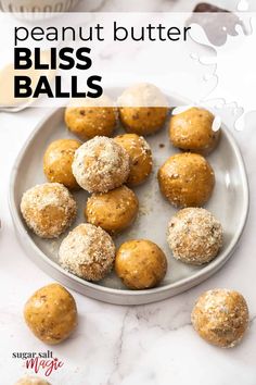 a plate full of peanut butter bliss balls on a marble table with the title above it