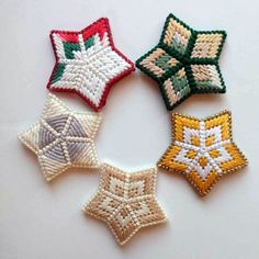 four different types of embroidered stars on a white surface