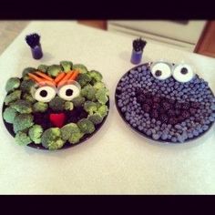 two cupcakes decorated to look like sesame the turtle and oscar the grouch