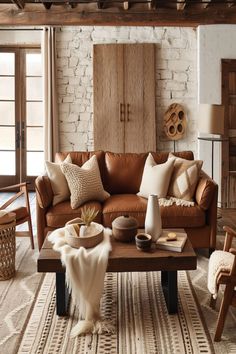 Rustic living room with a comfortable cognac leather sofa, wooden accents, and a white painted brick fireplace. Cognac Couch Living Room, Cognac Couch Living Room Ideas, Cognac Couch, Cognac Leather Sofa, Couch Living Room Ideas, Couch Living Room, Rustic Retreat, Cozy Fireplace, Living Room Ideas