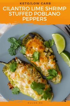 two stuffed poblano peppers on a plate with cilantro and lime garnish