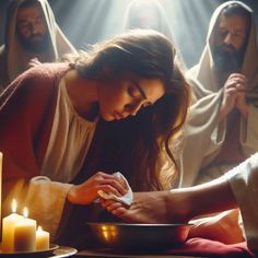 a woman is kneeling down in front of candles