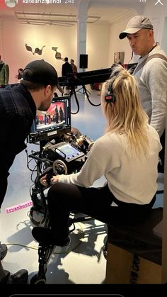 a man and woman looking at a video camera