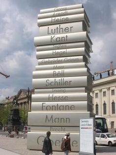 a tall stack of books sitting on the side of a road