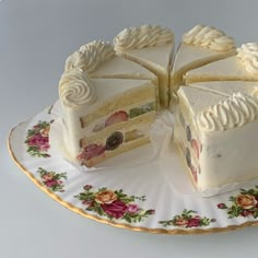 a white cake sitting on top of a floral plate